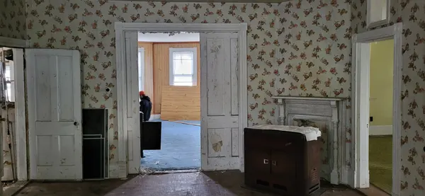 First floor before demolition with peeling wallpaper