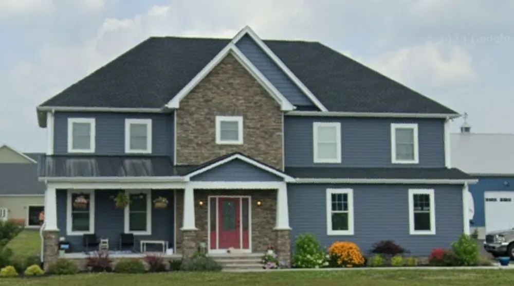 Two-story custom home with stone accents and a covered porch